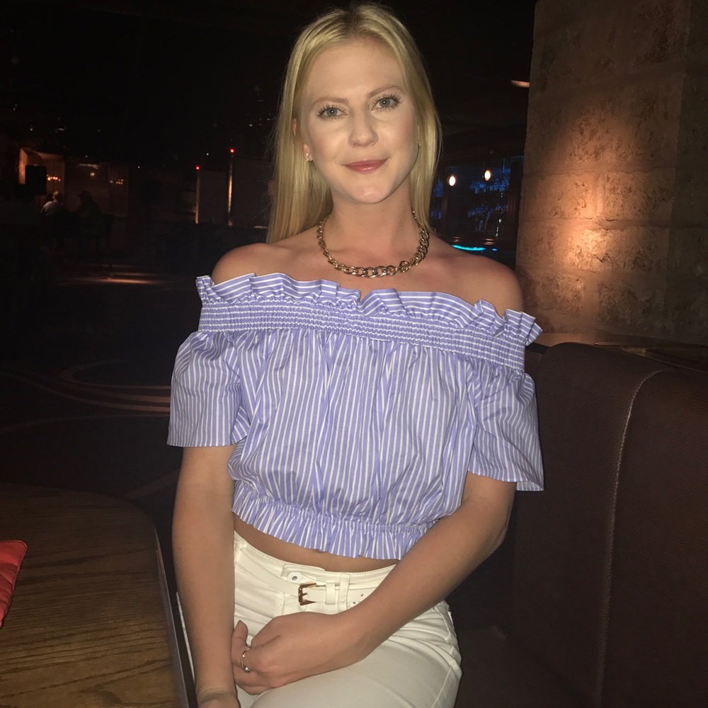 Off the shoulder crop top with ruffle edge and cute bow detail on the back.